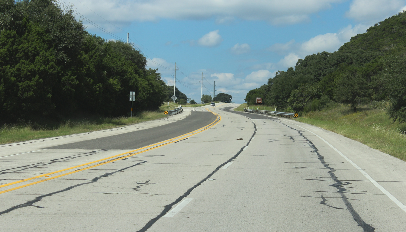 Road grade and equipment access for a Medina County drilling quote Rural road through wooded hills for Medina County equipment-access review
